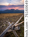 A rustic fence high in the Rocky Mountains at sunset. 76160649