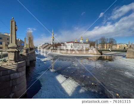 Russia, St. Petersburg, 01 April 2021: St. Nicholas Naval Cathedral belltower in a clear sunny day of spring, an ice drift on Kryukov and Griboyedov Canal, a view of seven bridges from the embankment Russia, St. Petersburg, 01 April 2021: St. Nicholas Naval Cathedral belltower in a clear sunny day of spring, an ice drift on Kryukov and Griboyedov Canal, a view of seven bridges from the embankment 76161315
