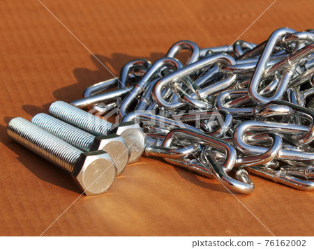 chrome chain and fasteners close-up scattered on the surface of the background for the magazine chrome chain and fasteners close-up scattered on the surface of the background for the magazine 76162002