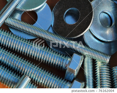 bolts nuts washers close-up scattered on the surface of the background for the magazine bolts nuts washers close-up scattered on the surface of the background for the magazine 76162004