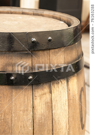 light beige oak barrel with a hoop close-up vertically close-up 76163288