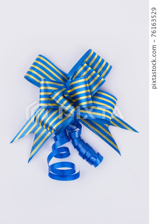 Festive gift bow of blue color. 76163529