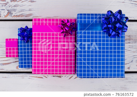 Group of gift boxes on wooden background. 76163572
