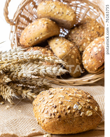 Sliced Multigrain. Rye bakery with crusty loaves and crumbs. Fresh loaf of rustic traditional bread with wheat grain ear or spike plant on natural cotton background. Bio ingredients, very healthy. Sliced Multigrain. Rye bakery with crusty loaves and crumbs. Fresh loaf of rustic traditional bread with wheat grain ear or spike plant on natural cotton background. Bio ingredients, very healthy. 76163755