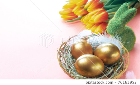 Easter Golden eggs in basket with spring tulips, white feathers on pastel pink background in Happy Easter decoration. Spring holiday concept. Easter Golden eggs in basket with spring tulips, white feathers on pastel pink background in Happy Easter decoration. Spring holiday concept. 76163952
