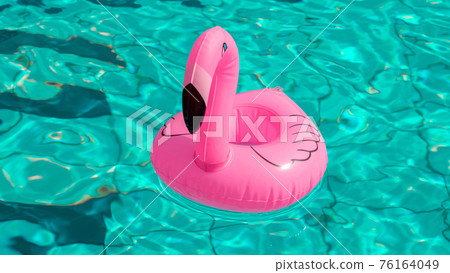 Hello summer. Pink inflatable flamingo in pool water for summer beach background. Trendy summer concept. 76164049