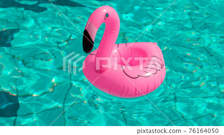 Summer sale. Pink inflatable flamingo in pool water for summer beach background. Minimal summer concept. 76164050