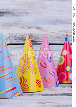 Set of party hats on wooden background. Set of party hats on wooden background. 76164239