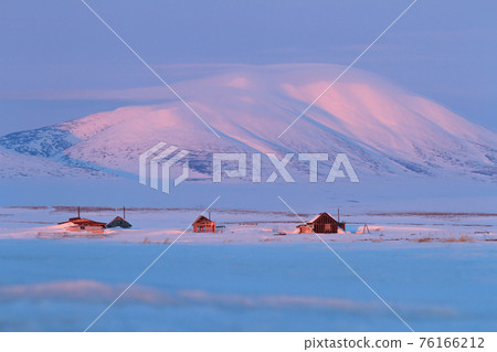 Winter landscape with snow-covered houses and a mountain. Winter landscape with snow-covered houses and a mountain. 76166212
