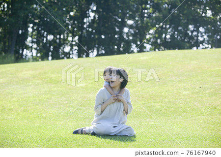 Parents and children playing on the grass in summer Parents and children playing on the grass in summer 76167940