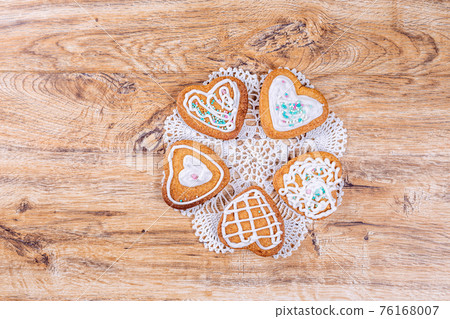 Homemade heart-shaped cookies, decorated with white icing with sprinkles Homemade heart-shaped cookies, decorated with white icing with sprinkles 76168007