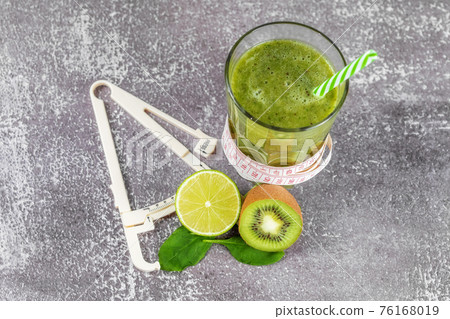 Fresh smoothie drink in a tall glass glass with a centimeter and a caliper Fresh smoothie drink in a tall glass glass with a centimeter and a caliper 76168019