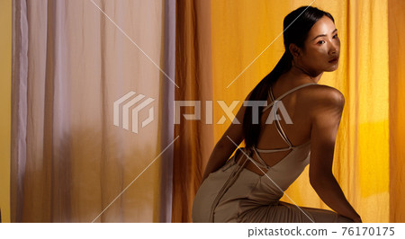 Fashion Beauty Woman has long straight black hair looks at camera 76170175