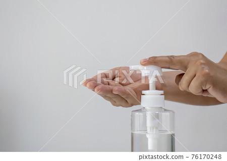 Women's hands are pressing the hand wash gel for Coronavirus or covid-19 prevention for the concept of health care and disease prevention. Women's hands are pressing the hand wash gel for Coronavirus or covid-19 prevention for the concept of health care and disease prevention. 76170248