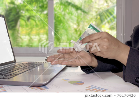 Business women are washing their hands with an alcohol gel to wash their hands to prevent coronavirus or Covid-19. Business women are washing their hands with an alcohol gel to wash their hands to prevent coronavirus or Covid-19. 76170426