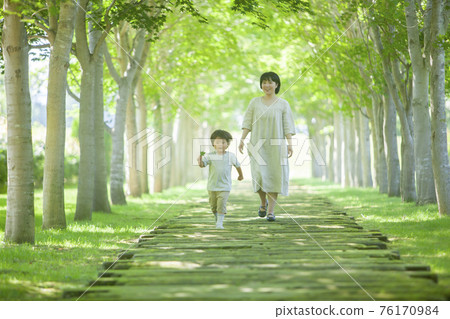 Boy reaching for a leaf 76170984