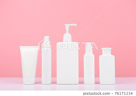 Set of cosmetic products for skin and body care on white table against bright pink background 76171134