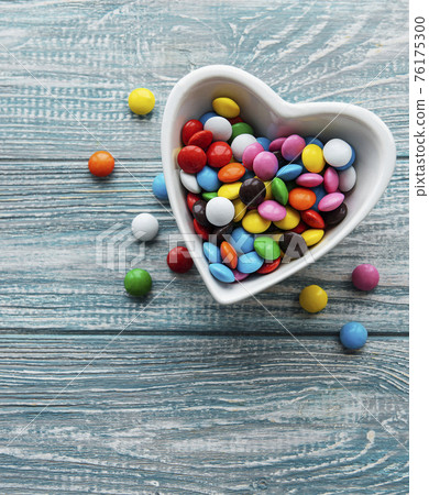 Bowl with multicolored dragee candies Bowl with multicolored dragee candies 76175300