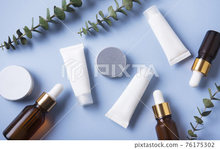 White tubes of cream on a blue background White tubes of cream on a blue background 76175302
