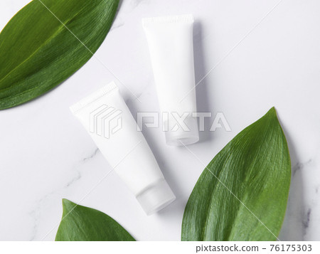 White tubes of cream on a marble background White tubes of cream on a marble background 76175303
