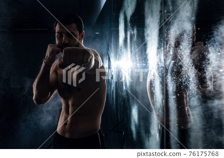 boxer training in the gym with reflection in low key photo for fight club advertisement 76175768