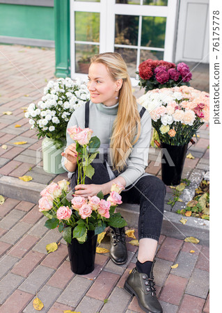 people, business, sale and floristry concept - close up of florist woman holding bunch at flower shop people, business, sale and floristry concept - close up of florist woman holding bunch at flower shop 76175778