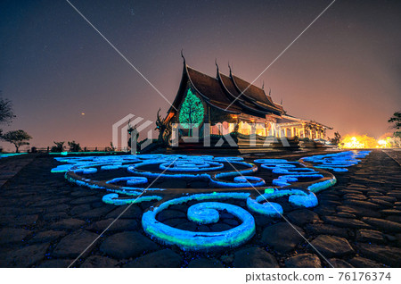 Church temple with bodhi tree glowing and fluorescence painting on the floor at Wat Sirindhorn Wararam or Wat Phu Prao at Ubon Ratchathani 76176374