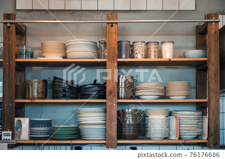 Kitchenware with dishware on kitchen wooden shelving Kitchenware with dishware on kitchen wooden shelving 76176686