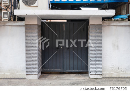 Black double door with handle on concrete white wall Black double door with handle on concrete white wall 76176705