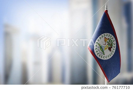 A small flag of Belize on the background of a blurred background A small flag of Belize on the background of a blurred background 76177710