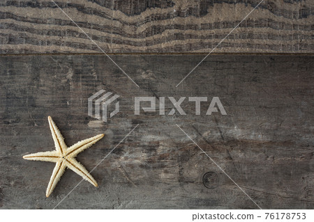 Starfish on a rustic wooden background 76178753