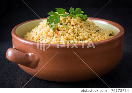 Couscous with vegetables in bowl 76178754