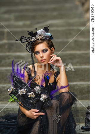 Beautiful stylish bride in a black dress sits on the stairs in Florence, Italy Beautiful stylish bride in a black dress sits on the stairs in Florence, Italy 76179549