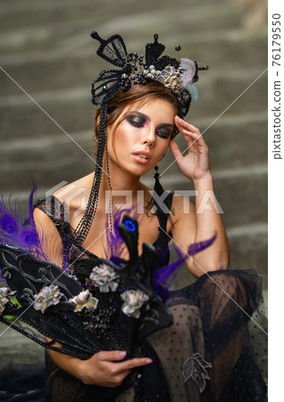 Beautiful stylish bride in a black dress sits on the stairs in Florence, Italy Beautiful stylish bride in a black dress sits on the stairs in Florence, Italy 76179550