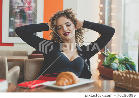 Nice young woman relaxing in city street cafe Nice young woman relaxing in city street cafe 76180099