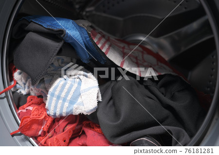 close up of cloths in a washing machine. 76181281