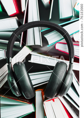 Audiobooks with wireless headphones and player concept Audiobooks with wireless headphones and player concept 76181660