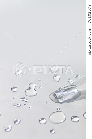 Pipette with serum or fluid hyaluronic acid on gray background Pipette with serum or fluid hyaluronic acid on gray background 76182078