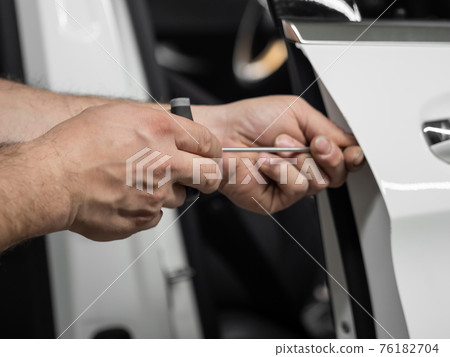 Repairing dents in a car Repairing dents in a car 76182704