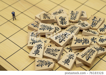 Shogi pieces and miniature businessmen 76183328