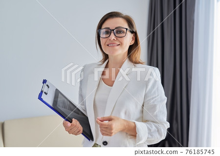 Business portrait in the office, confident smiling middle-aged businesswoman Business portrait in the office, confident smiling middle-aged businesswoman 76185745