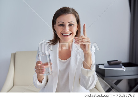 Video conference, specialist talking, counseling, helping patient online, holding glass of water Video conference, specialist talking, counseling, helping patient online, holding glass of water 76185768