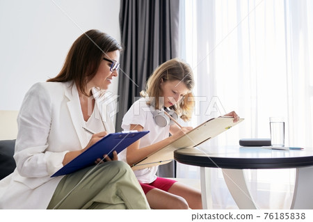 Professional family psychologist helping child, teacher social worker talking to a girl Professional family psychologist helping child, teacher social worker talking to a girl 76185838