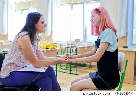 Woman school psychologist talking and helping student, teenage girl Woman school psychologist talking and helping student, teenage girl 76185947