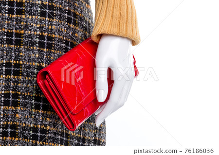Close up mannequin hand with red wallet. Close up mannequin hand with red wallet. 76186036