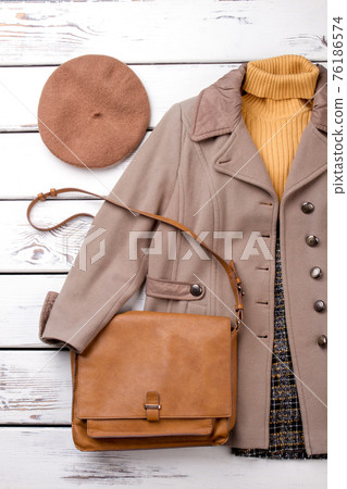 Autumn clothes set on wood background. Autumn clothes set on wood background. 76186574