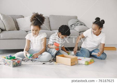 Children play with a colored constructor on floor Children play with a colored constructor on floor 76187625