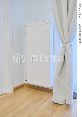 White heating radiator with temperature thermostat in interior of apartment White heating radiator with temperature thermostat in interior of apartment 76187754