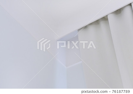 Interior details close up. White wall, ceiling, cornice niche, curtains on the window 76187789