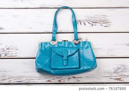 Flat lay blue leather purse. Flat lay blue leather purse. 76187800